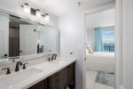 Bright jack n jill bathroom connects the two guest rooms offering dual vanity sinks and tub/shower combo.